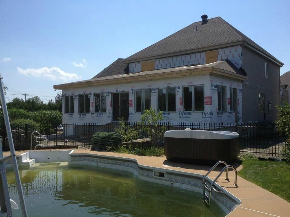 Une grande maison avec une piscine devant
