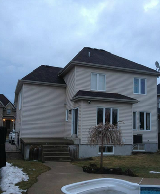 Une grande maison avec une piscine devant