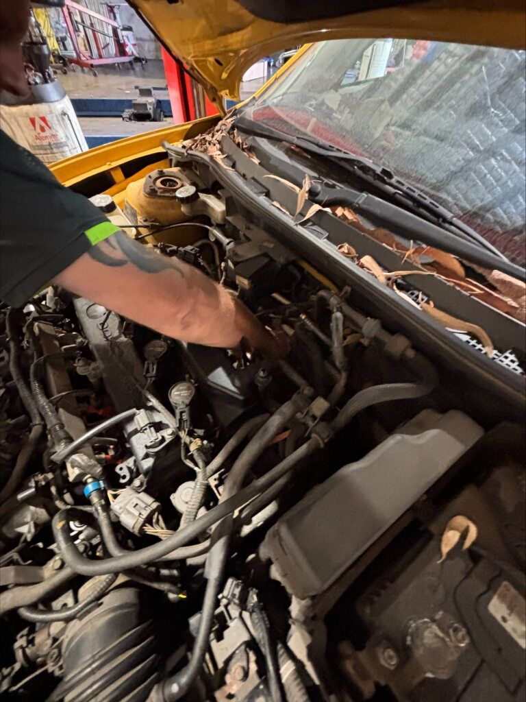 A Man is Checking the Engine  of a Car — Kawana Auto Service In Warana, QLD