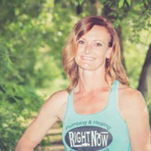 A woman is wearing a blue tank top that says `` right now ''.