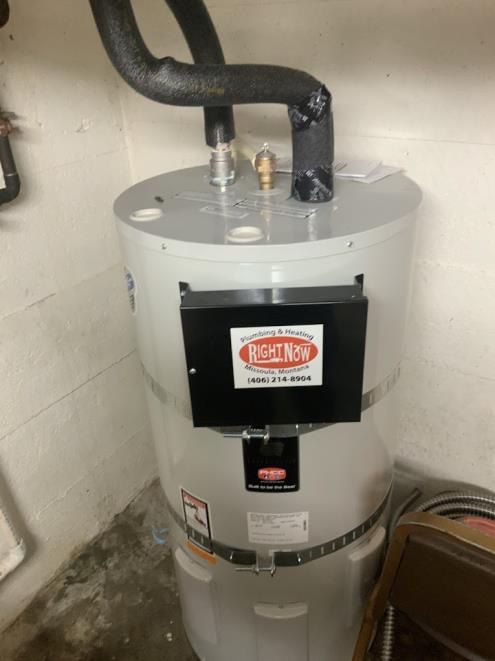 A reliance water heater is sitting in a corner of a room