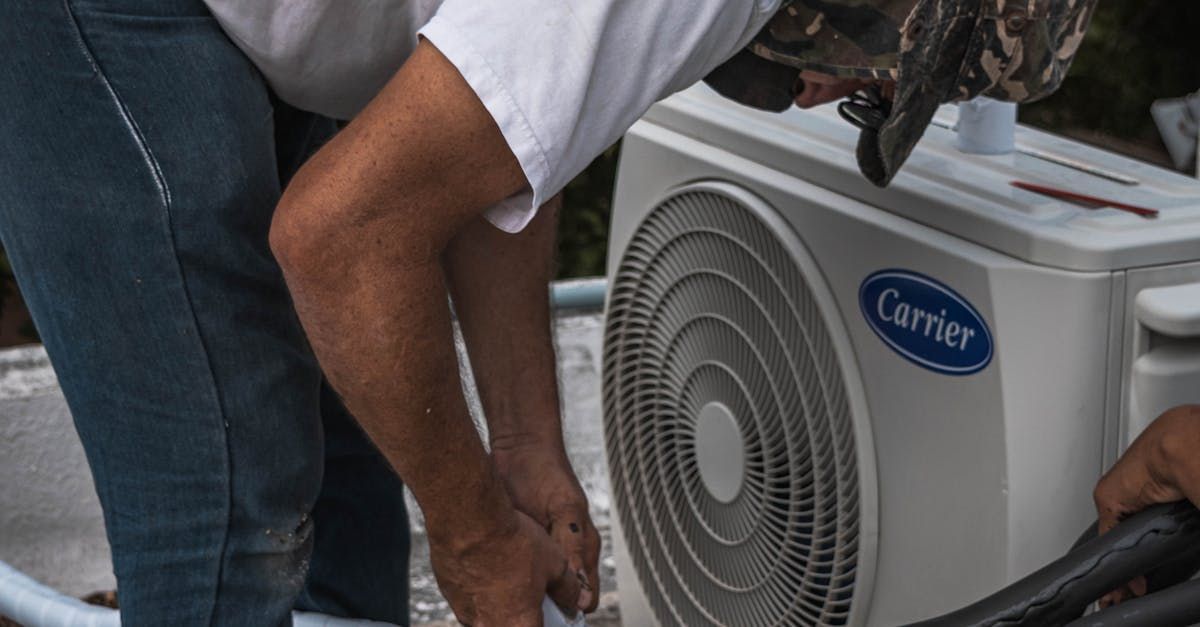 A man is working on a carrier air conditioner.