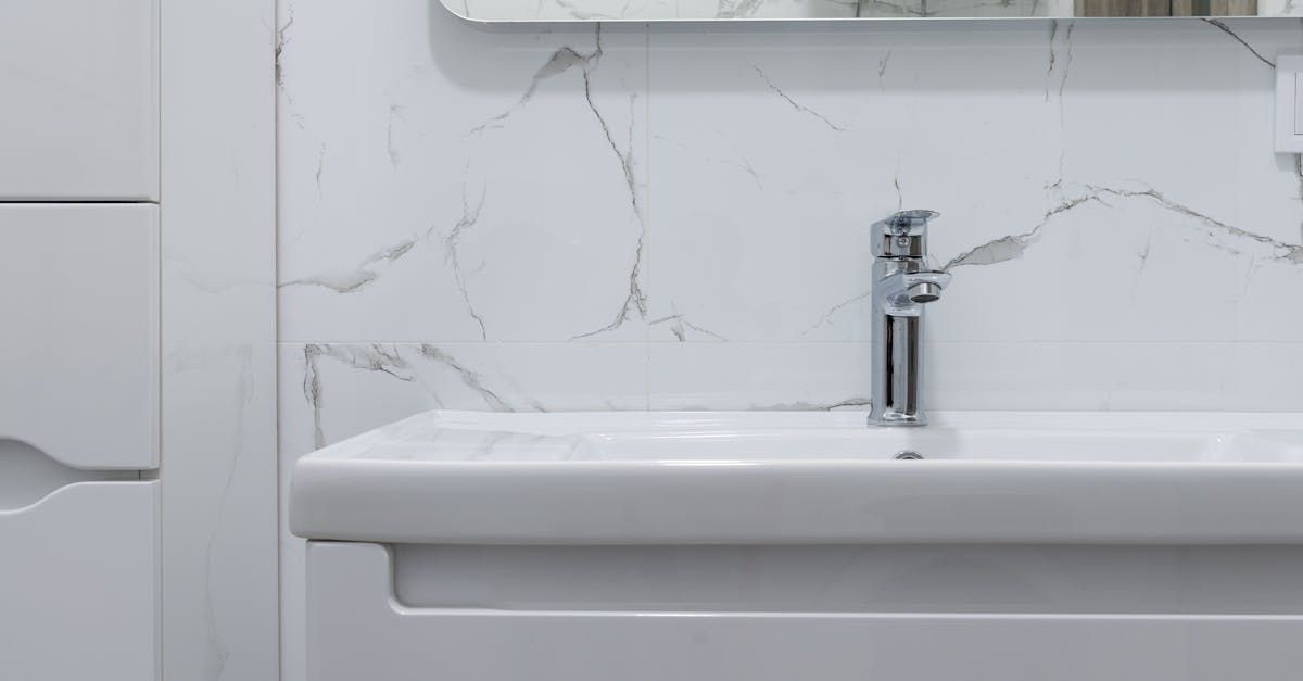 A bathroom with a sink , mirror and cabinet.