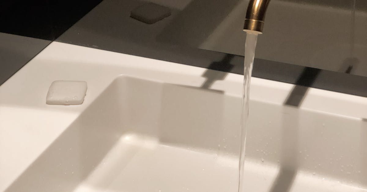 A bathroom sink with water running from a faucet.