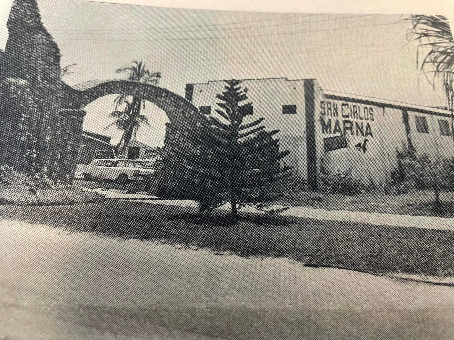 A black and white photo of a building that says san carlos marina