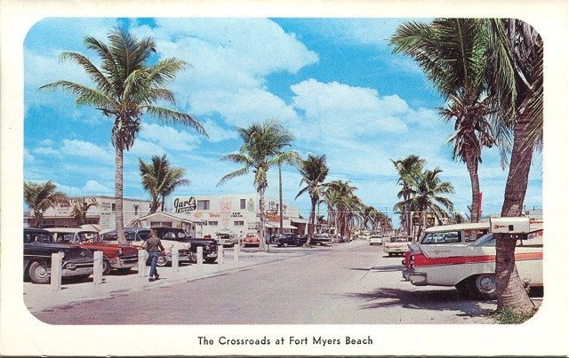 A postcard of fort myers beach with palm trees and cars