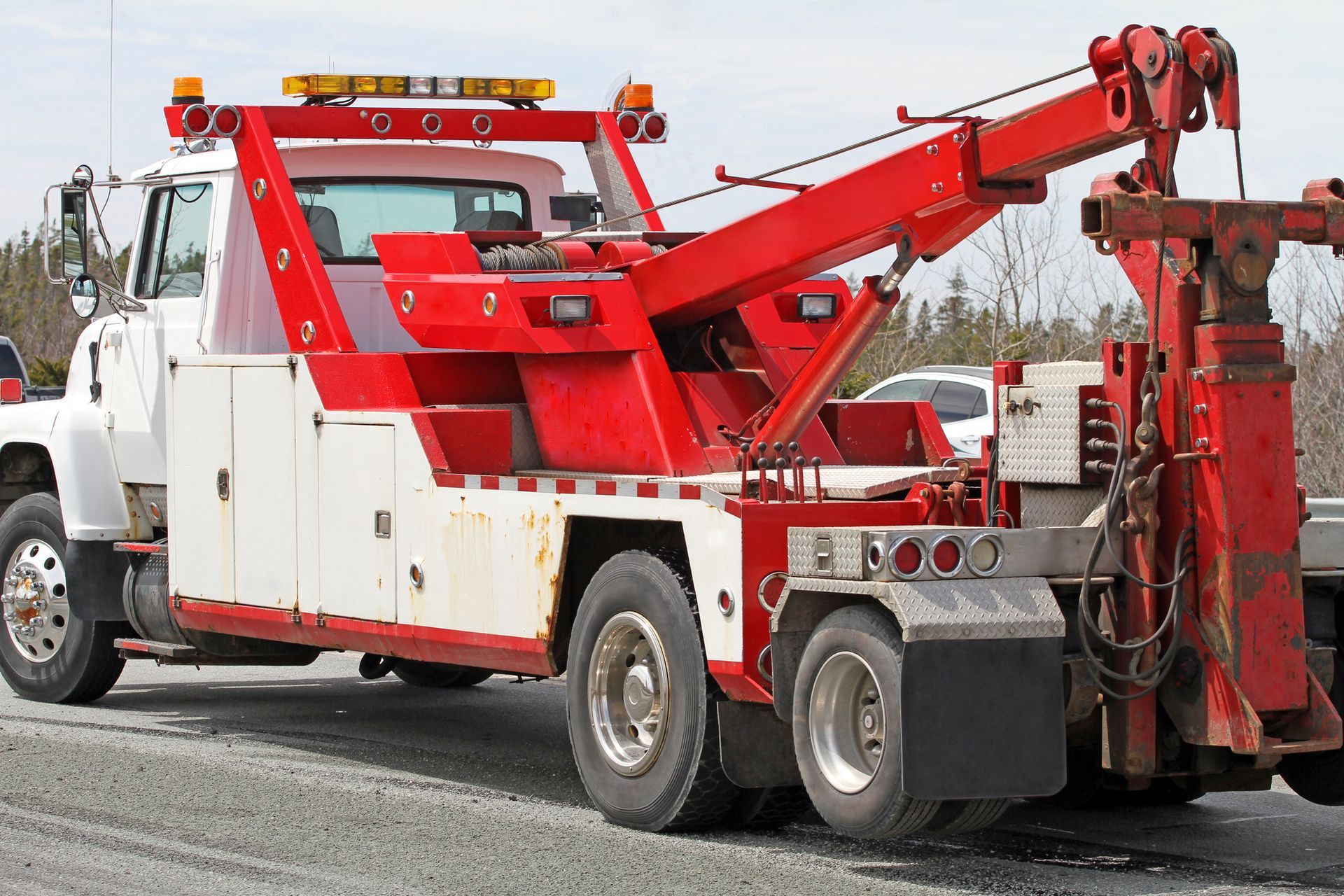 A Red And White Tow Truck Is Parked On The Side Of The Road - Sanford, NC - Landmark Towing of Sandford