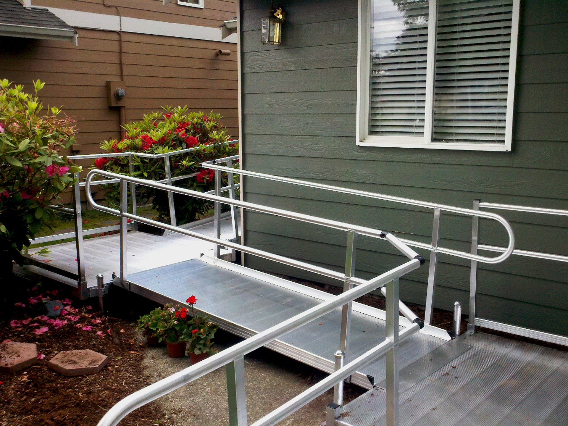 A wheelchair ramp leading to a green house