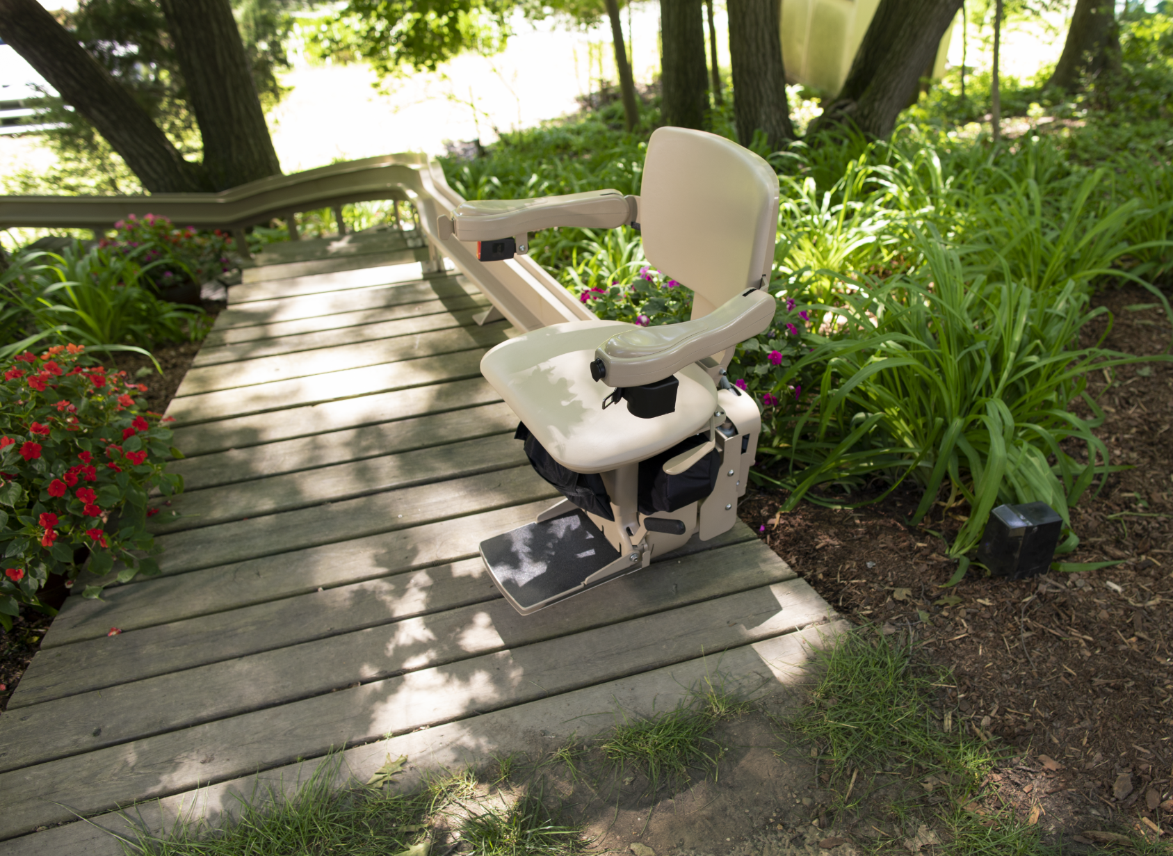 A chair is sitting on a wooden deck next to a staircase.