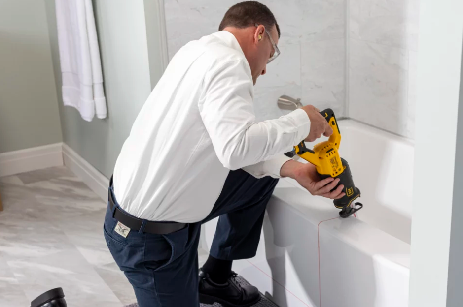 A man is installing a tubcut from Altamria Ltd.