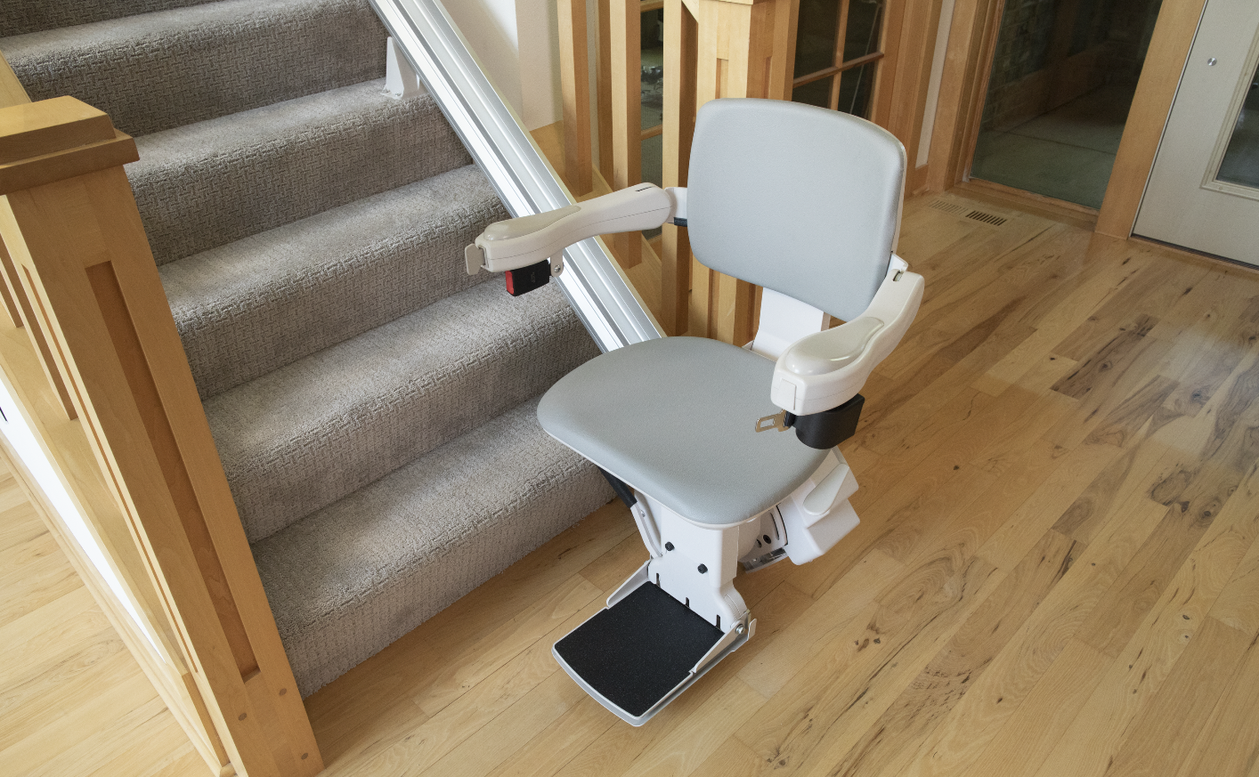 A stair lift installed by Altamira Ltd. at the bottom of the steps