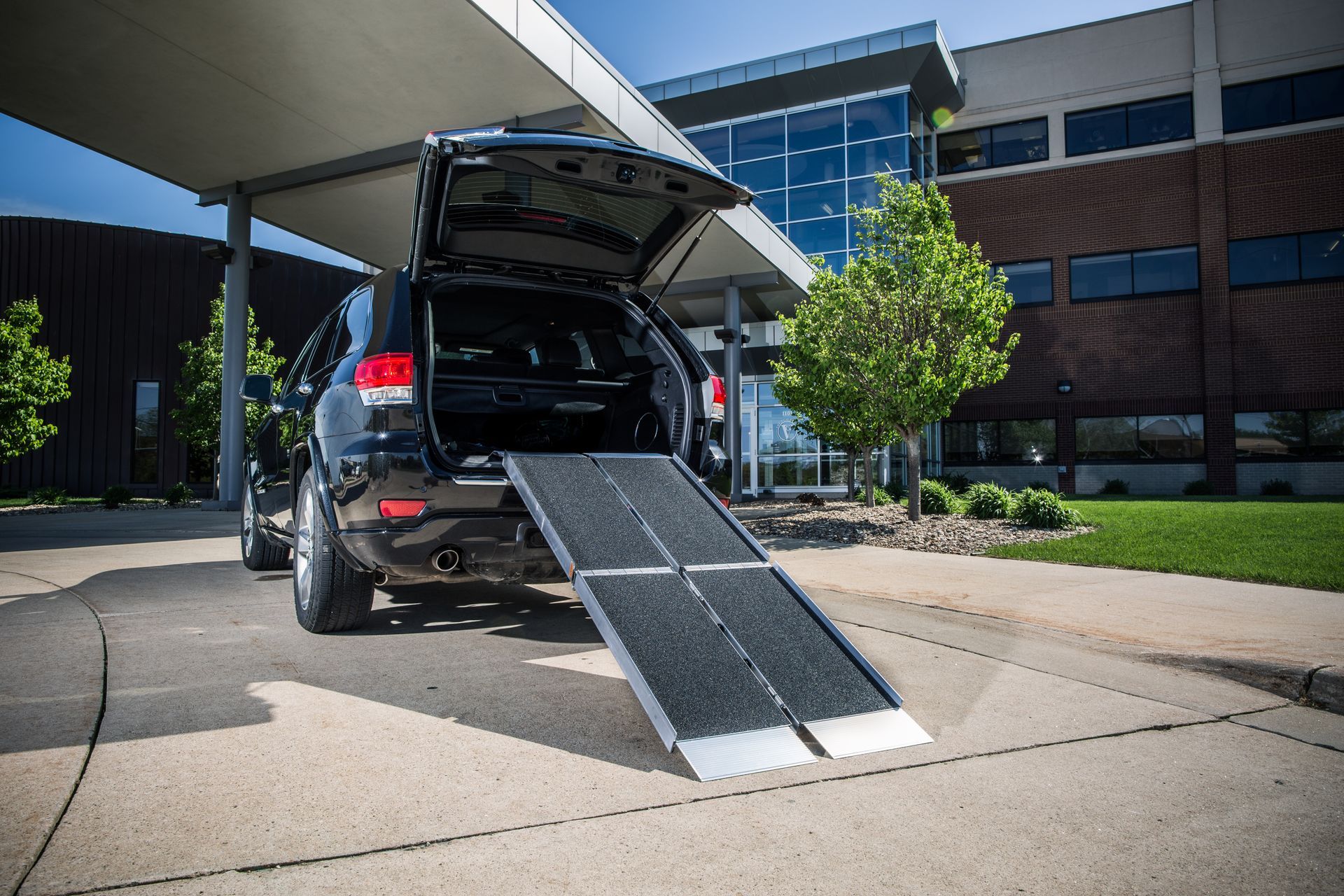 A car with a ramp attached to the back of it b Altamira Ltd.