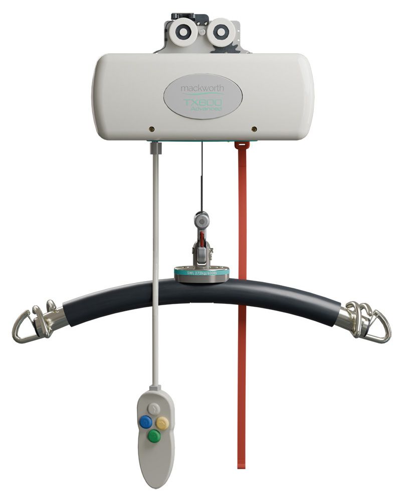 Ceiling-mounted patient lift with remote, white and black, for assisted transfers.