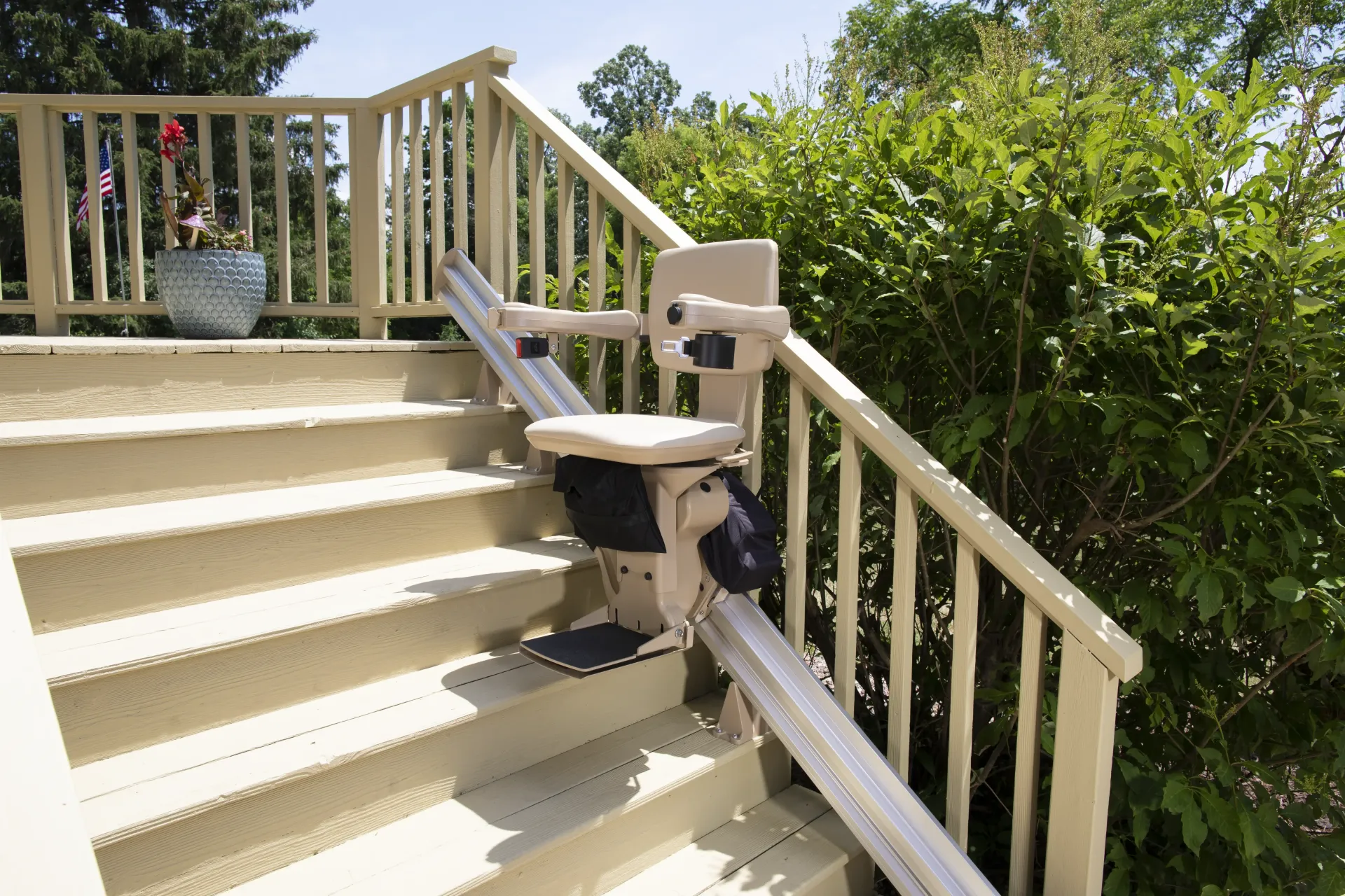 An outdoor stair lift is attached to the side of the stairs by Altamira Ltd