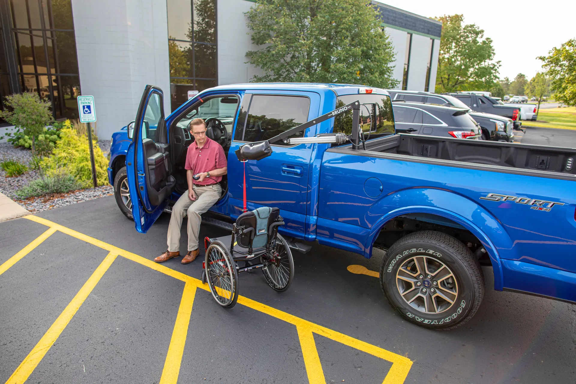 A blue truck with a bruno wheelchair lift attached to the back by Altamira Ltd. 