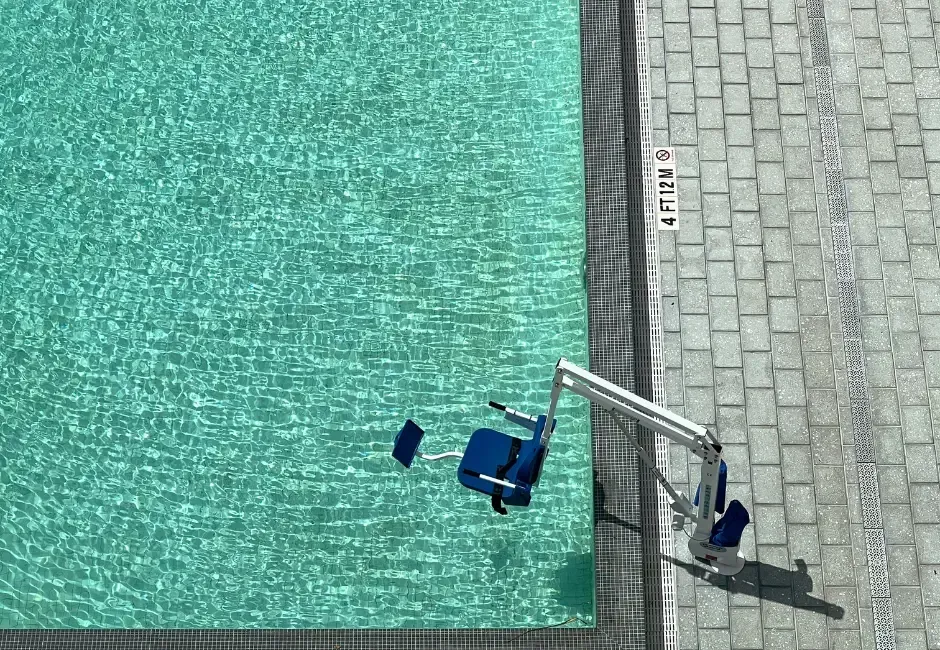 An aerial view of a swimming pool with a wheelchair in the water.