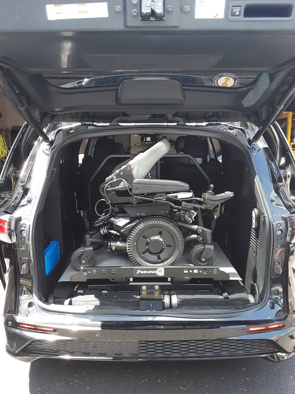 A wheelchair is sitting in the back of a car.