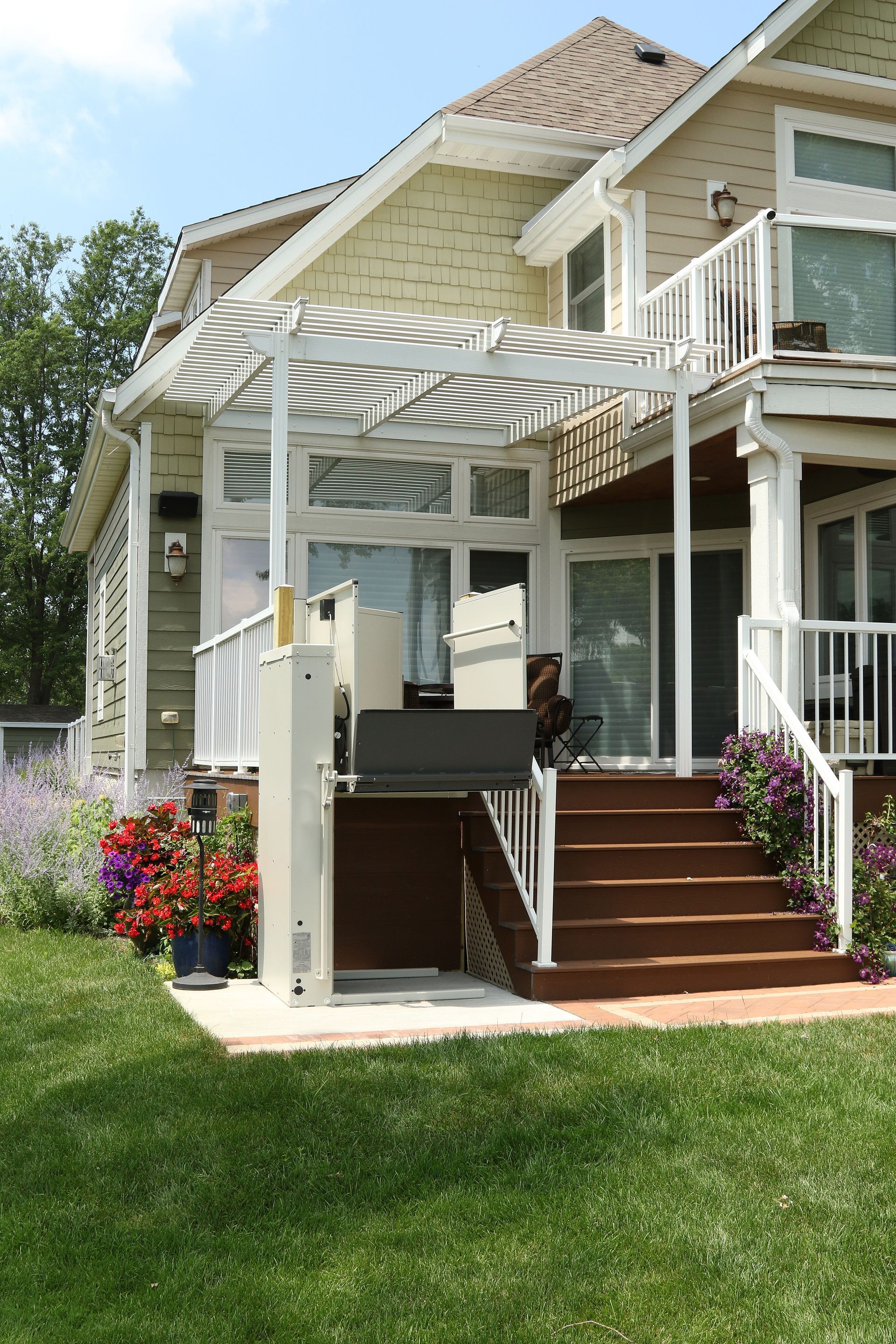 A house with stairs and a lift on the side of it.