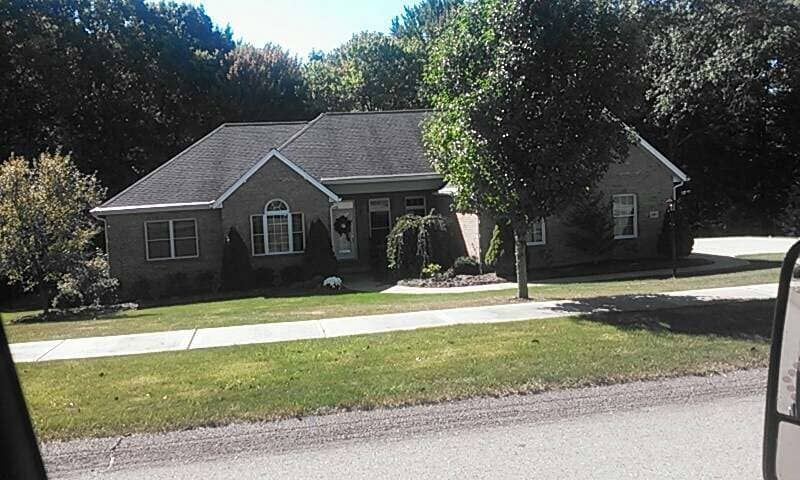 A house with a black roof and a lot of windows