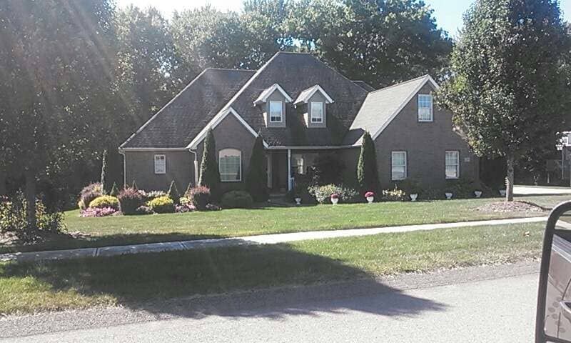 A house with a black roof and a lot of windows