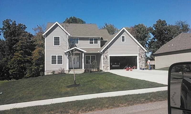 A large house with a car parked in front of it