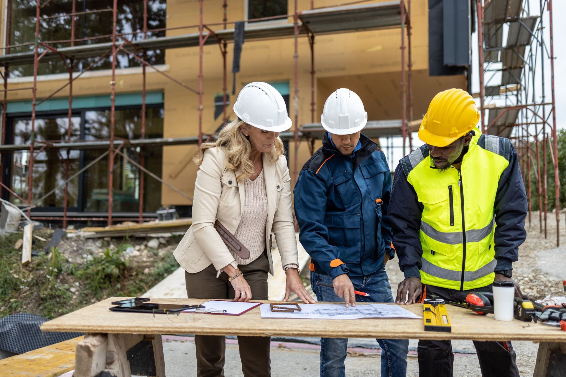 Company reps review renovation plans for a residential property. Company reps review renovation plans for a residential property.