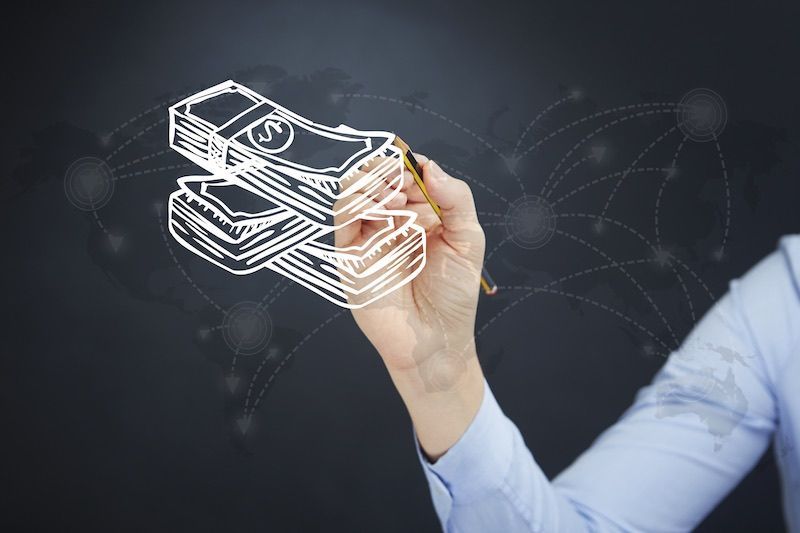 Hand drawing stacks of money with dotted lines on a dark background.