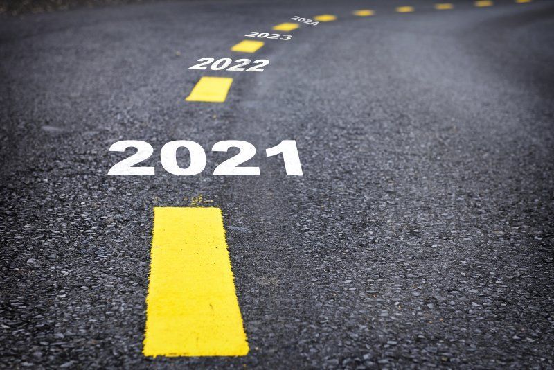 Road marked with years 2021, 2022, 2023, and 2024, symbolizing a journey or progression forward.