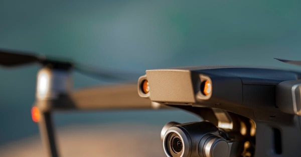 A close up of a drone with a camera attached to it.
