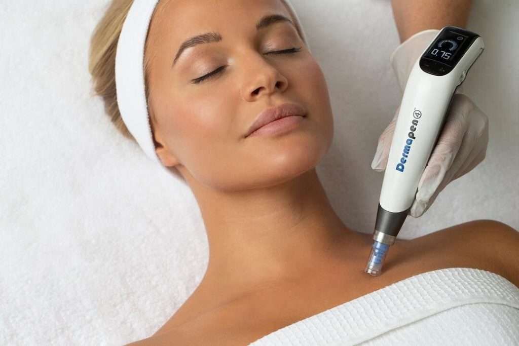 A woman is getting a facial treatment with a machine.