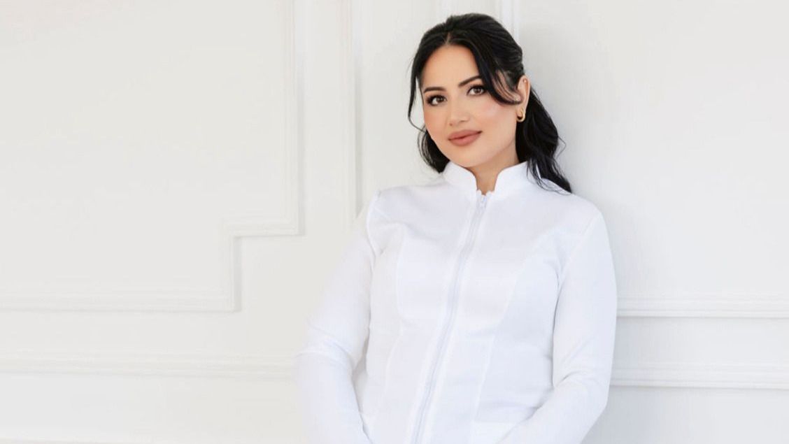 A woman is applying lip fillers to another woman 's lips