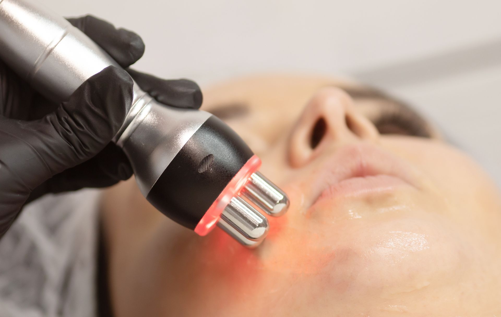 A woman is getting a laser treatment on her face.