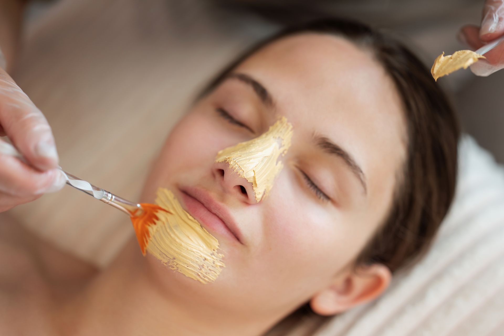 A woman is getting a facial treatment at a spa.