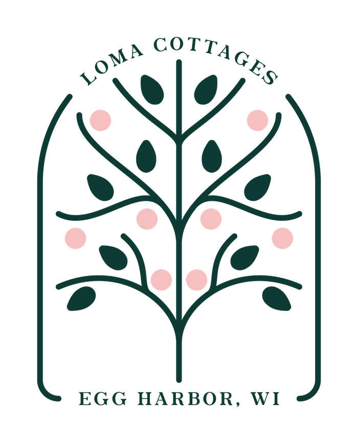 A logo for a cottage in egg harbor wi with a tree and leaves.