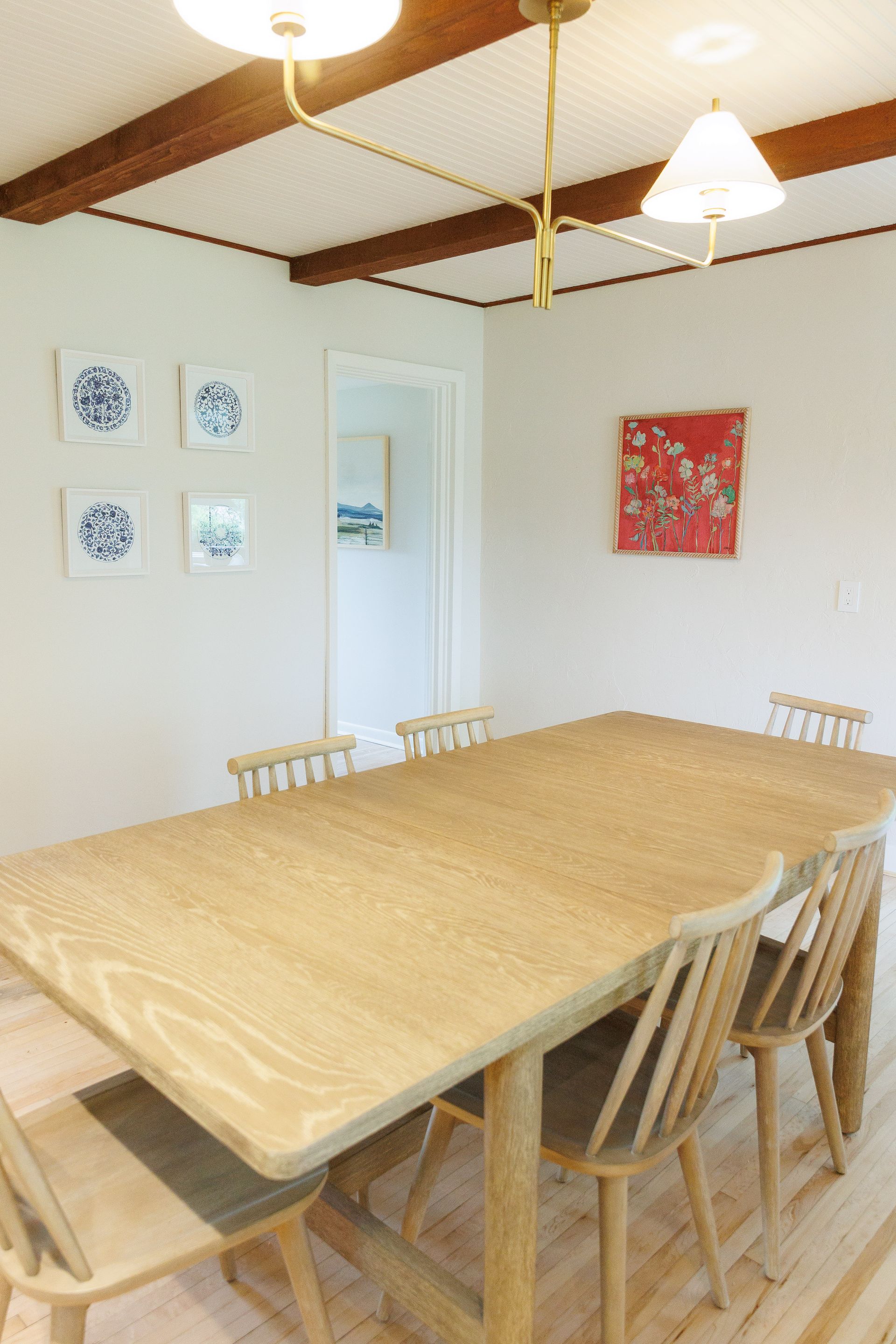 A dining room with a wooden table and chairs