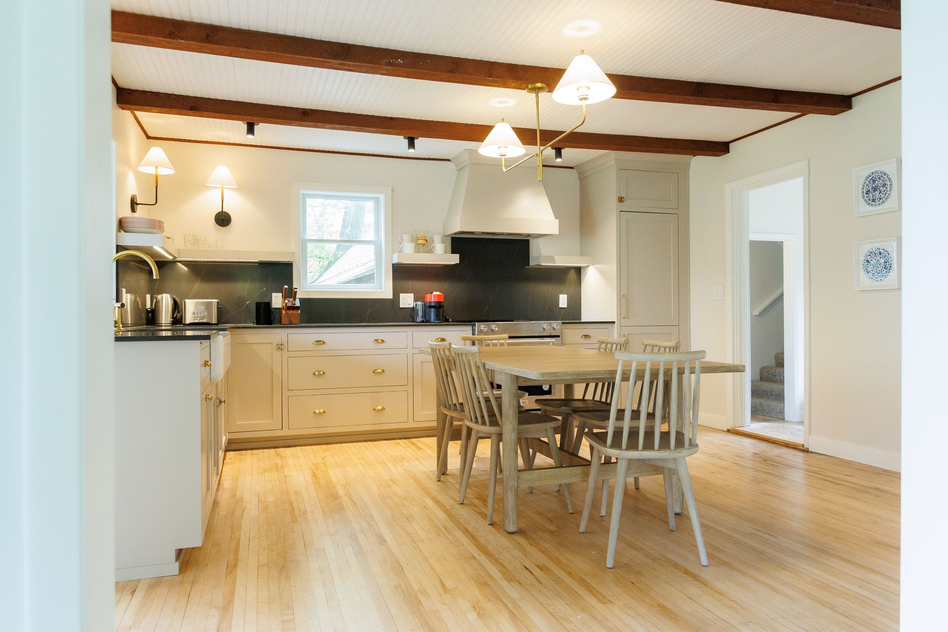 A kitchen with a table and chairs in it