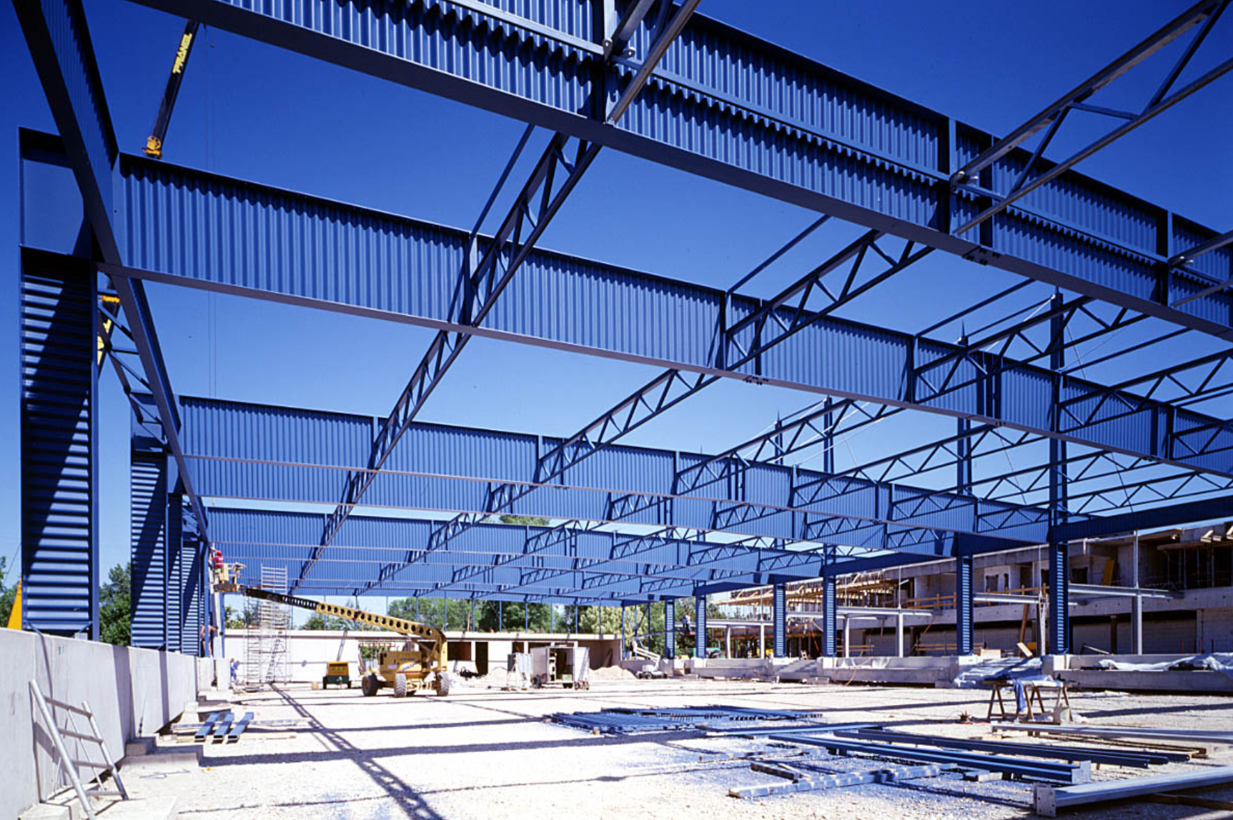 A large building under construction with a blue sky in the background
