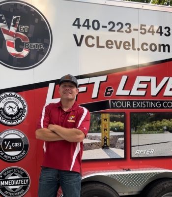 A man stands in front of a vclevel trailer