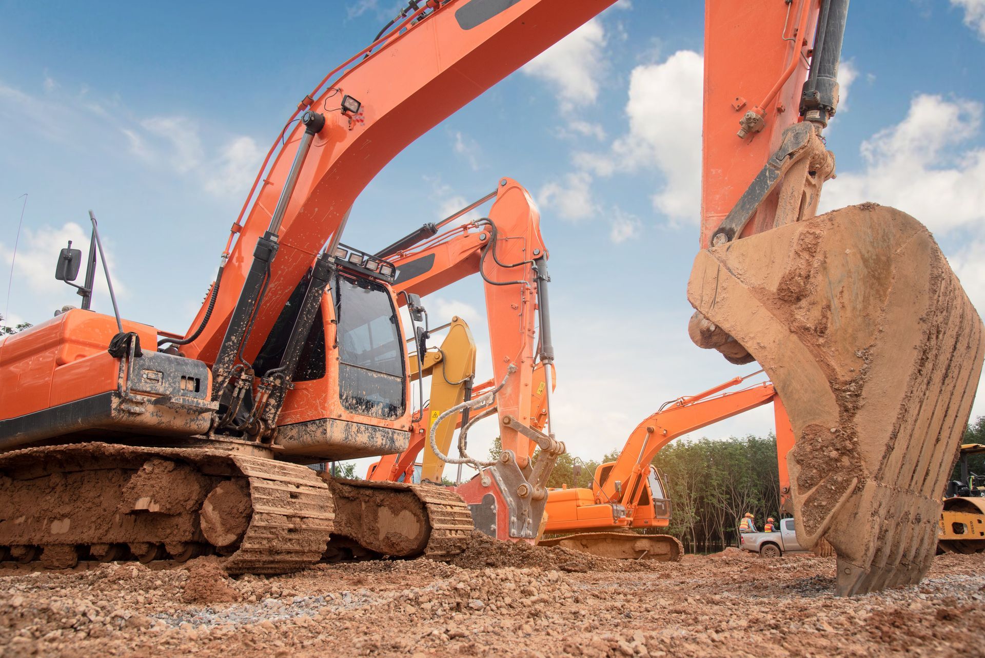 A group of excavators are working on a construction site.