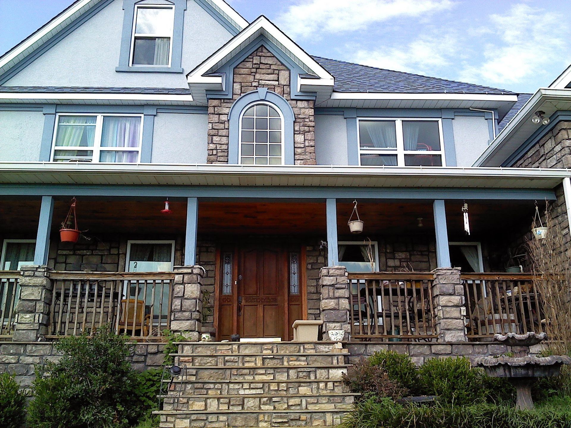 A large house with a large porch and stairs