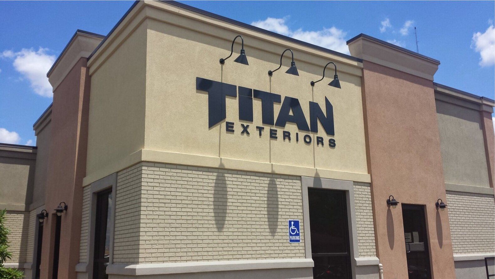 A building with a sign that says titan exteriors