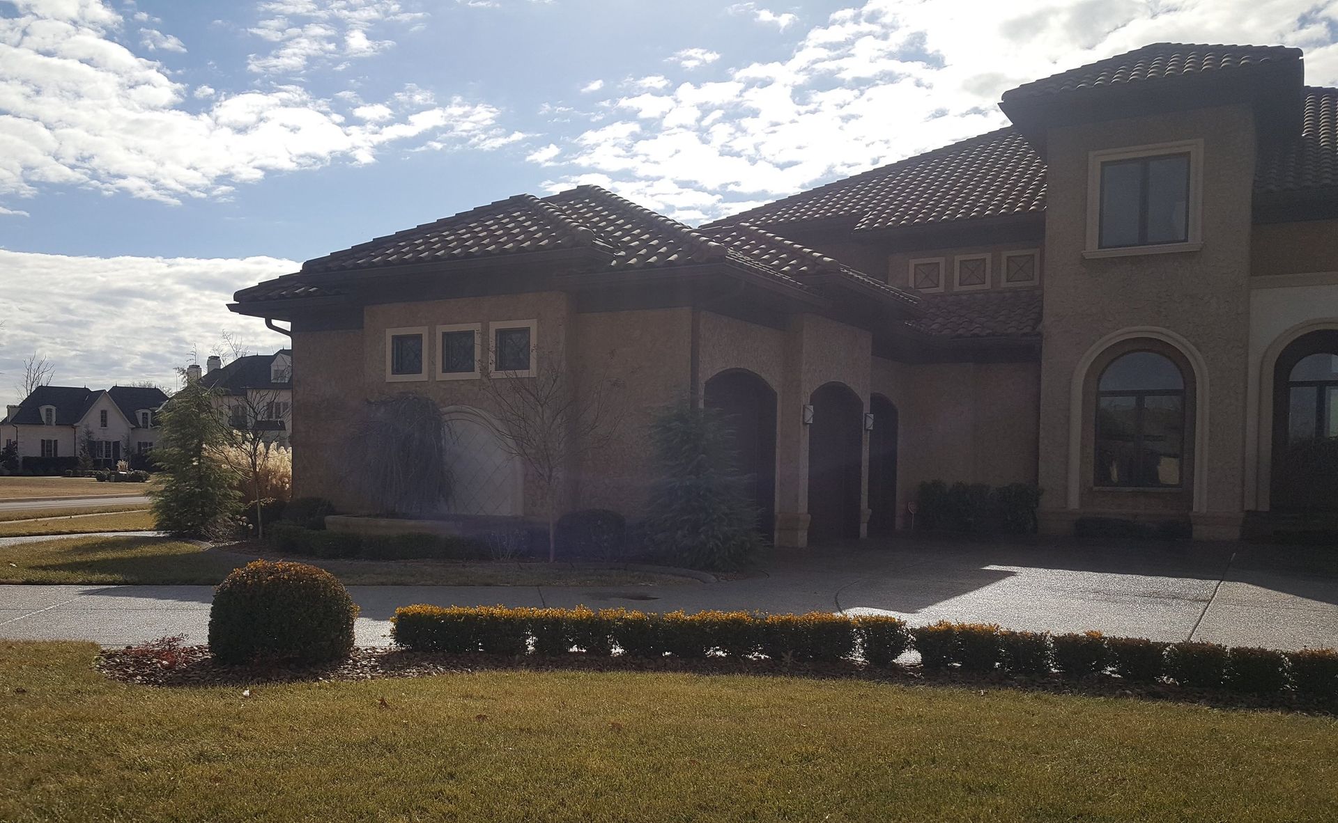 A large house with a tiled roof and arched windows