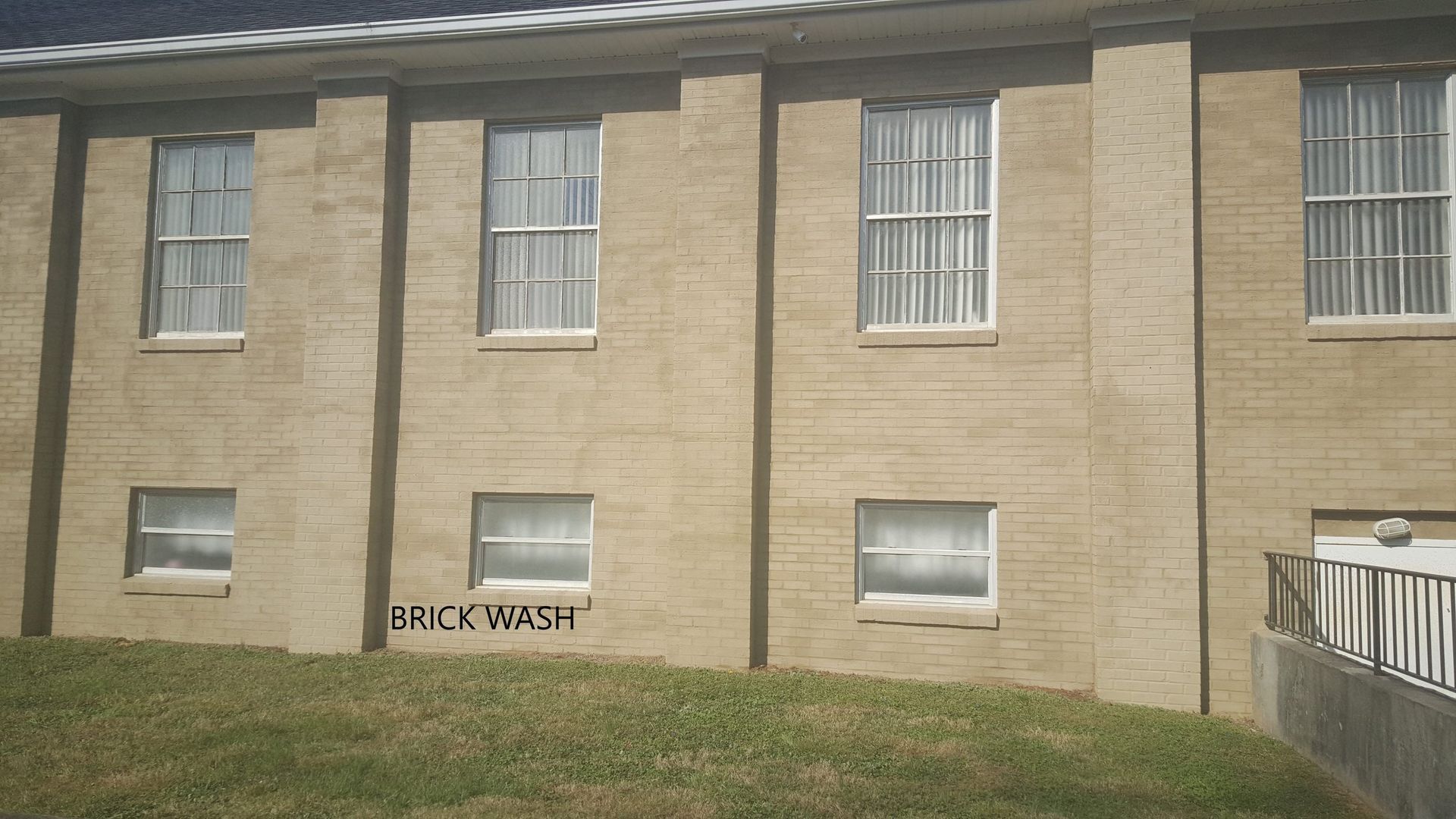 A brick building with graffiti on the side that says milkwash