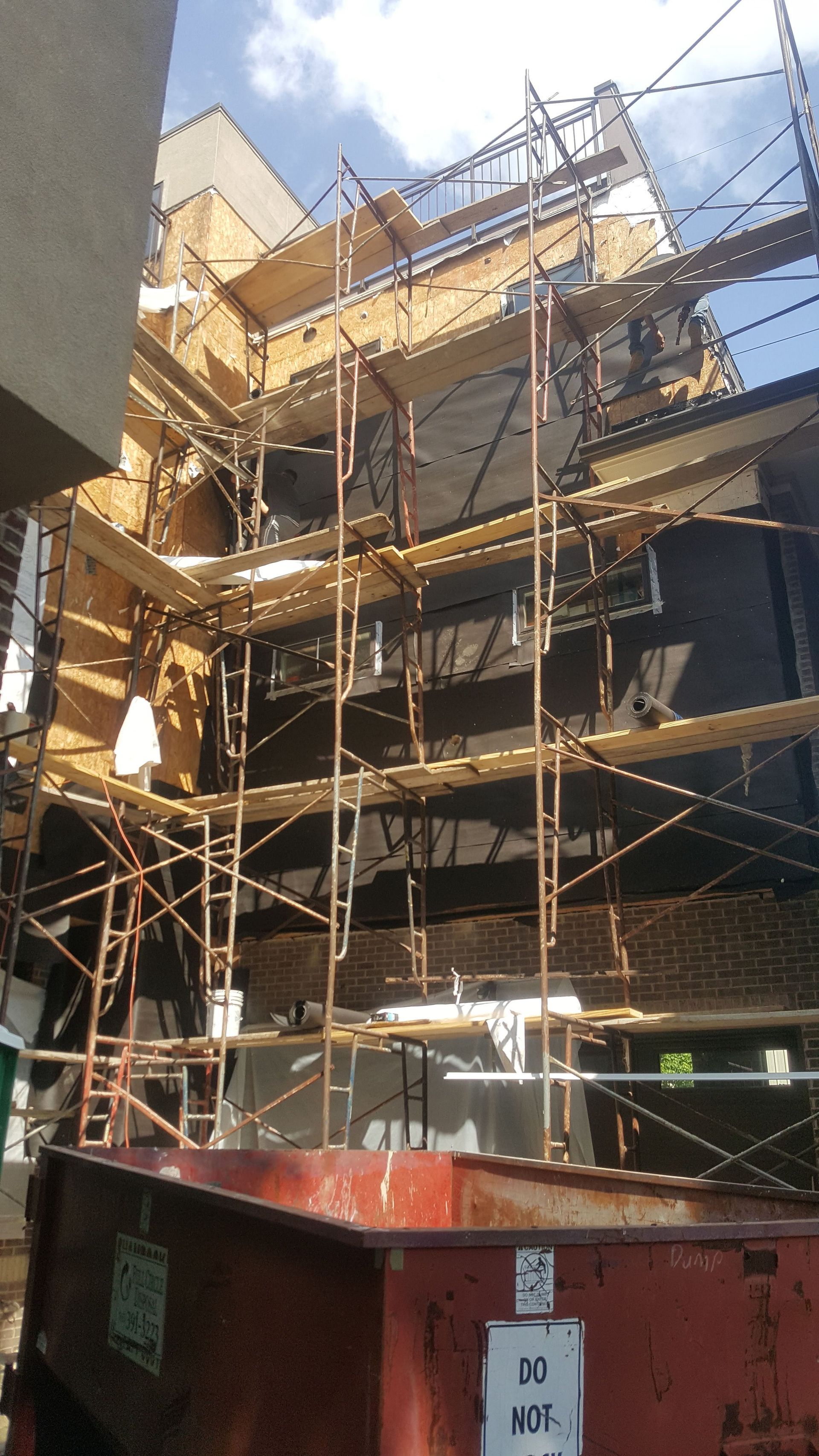 A large building under construction with scaffolding on the side of it