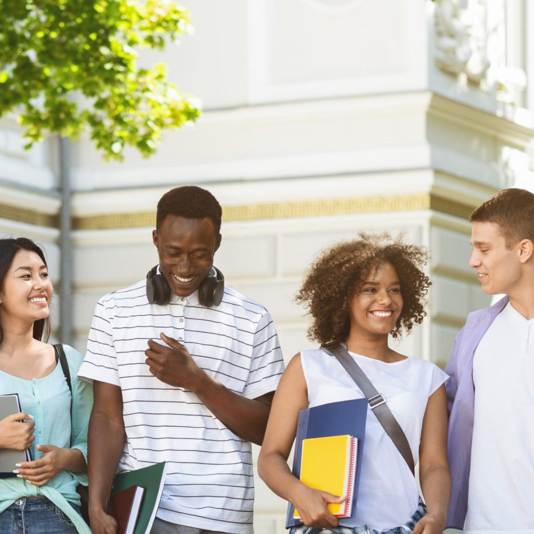 A group of students are standing outside of a building
