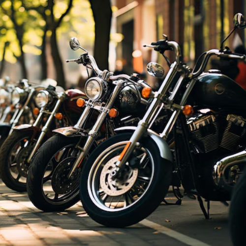 A row of motorcycles are parked on the side of the road.