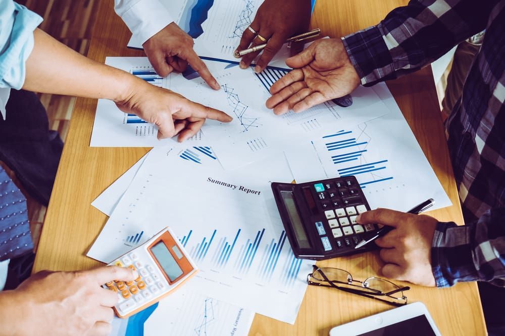 People Analyzing Financial Data With Calculators — Fit Financial Group in Leumeah, NSW