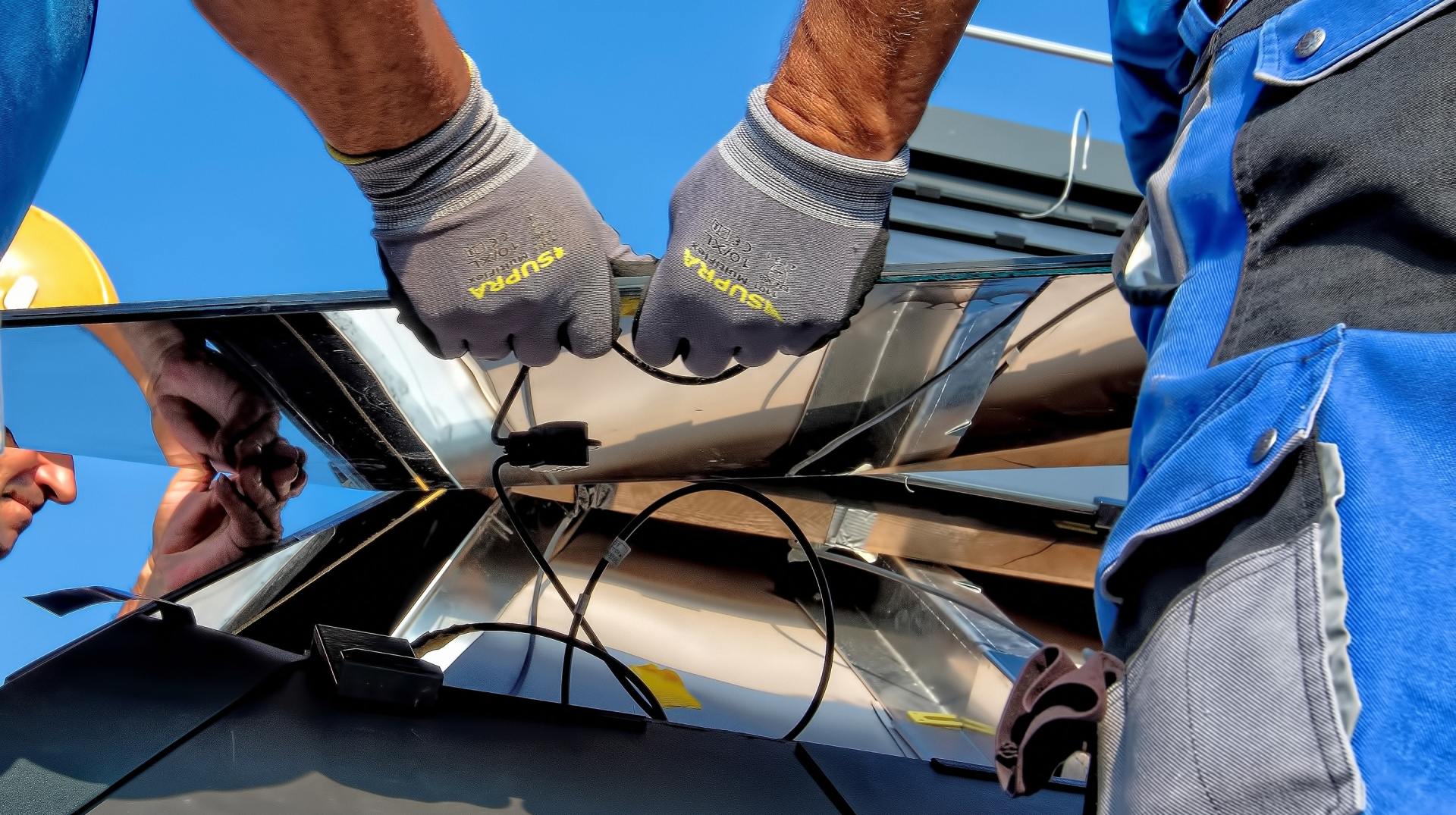 Close up of man's hands wiring new solar panels