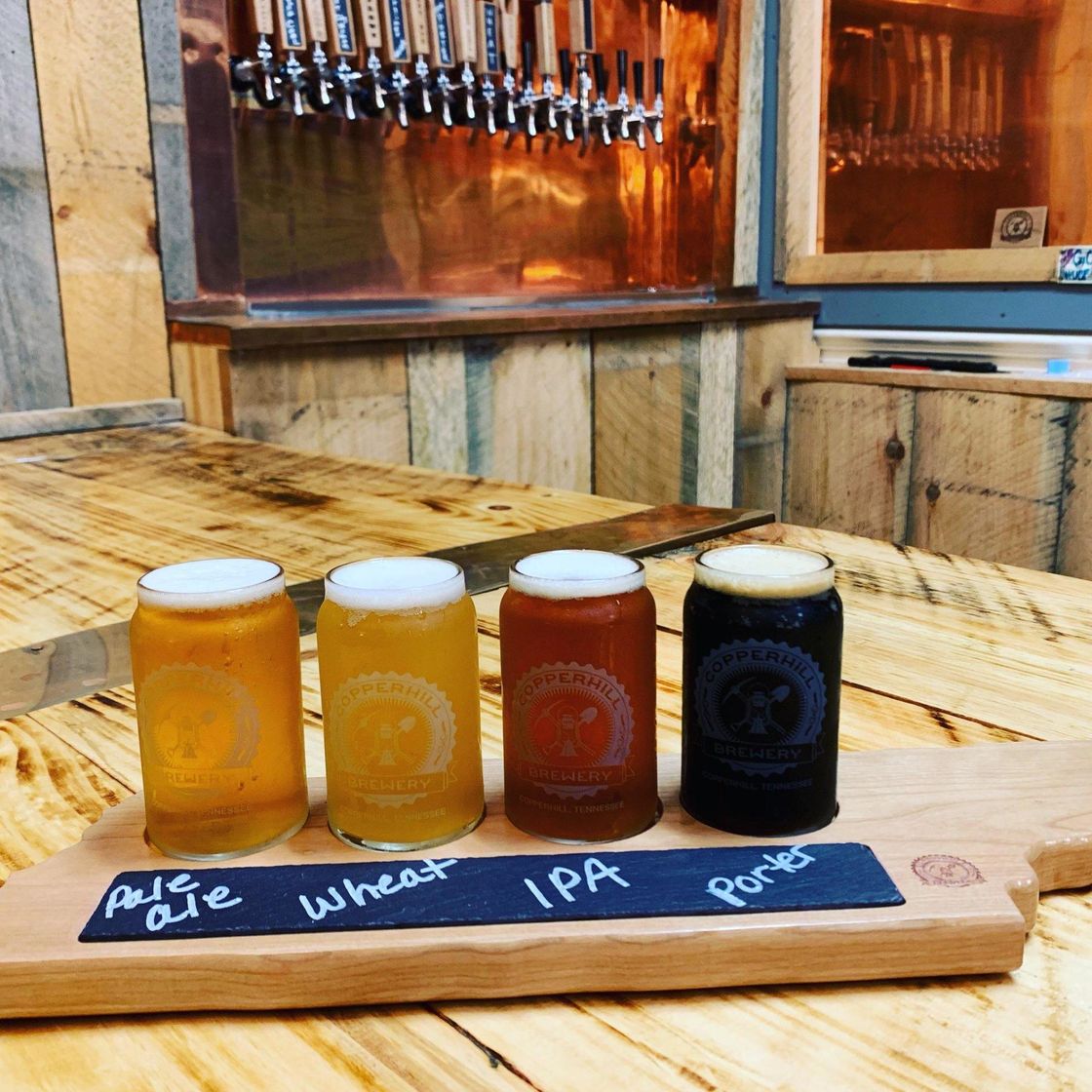 A flight of four glasses of craft beer.