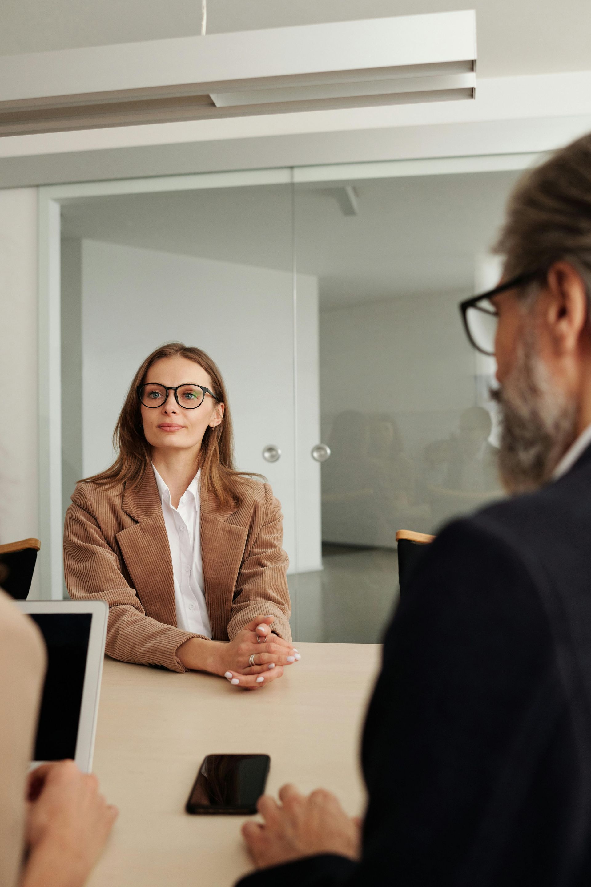A man and a woman are sitting at a table having a job interview.